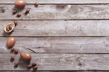 chocolate eggs on old wooden background