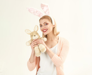 happy woman in bunny ears with toy. Woman in rabbit bunny ears. Happy easter. Spring holiday. Girl...