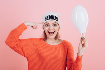 Beautiful minds inspire others. Happy woman hold light bulb pointing at head. Sensual woman wear...