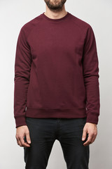 partial view of man in casual burgundy sweatshirt with copy space isolated on grey