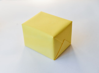 yellow gift box on a white background. winter holidays, pompom from threads, warm. unusual
