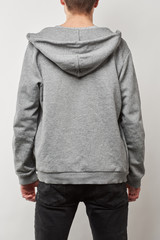 back view of man in grey hoodie with copy space isolated on white