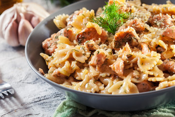 Creamy farfalle pasta with salmon, parmesan cheese and dill