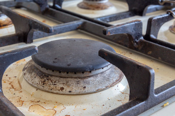 Dirty gas stove burners in kitchen room 