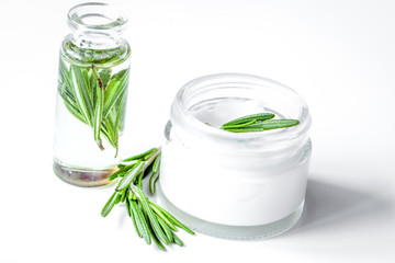 organic cosmetics with extracts of herbs rosemary on white background
