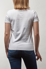 Obraz premium back view of young woman in casual white t-shirt with copy space isolated on white