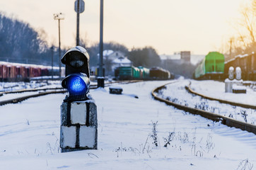 Vintage railway traffic light on an old snow covered railway station. Trains, rails, travel,...
