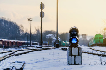 Vintage railway traffic light on an old snow covered railway station. Trains, rails, travel,...