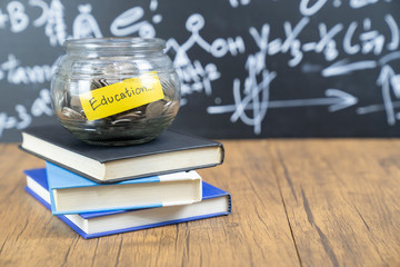 glass jar saving money scholarship for education in future on wood table,vintage. - Image