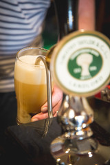 glass of beer being poured