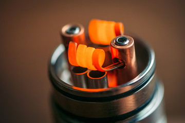 Warming up to red new Alien Clapton Coils on vape device RDA, macro photo