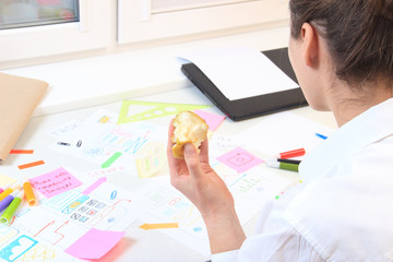 App developer snacking apple in the workplace.