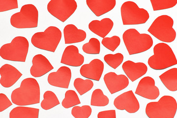 Valentine's day. Lots of red cut out hearts of different sizes on a white background. Isolate