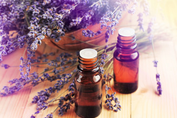 Essential oil of lavender aromatic plant. Dropper Bottles, purple dried holistic flowers on wooden...