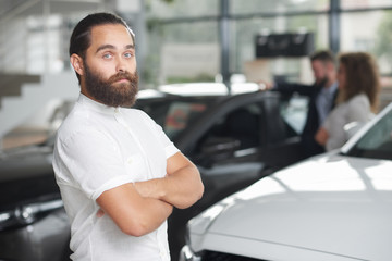 Handsome customer of car dealership posing.