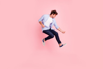 Fototapeta na wymiar Full length body size photo of jumping high crazy he his him handsome playing imagine electric guitar in arms hands harsh face wearing casual jeans checkered plaid shirt isolated on rose background