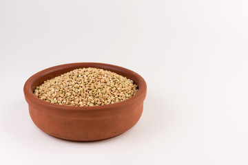 Natural fresh green buckwheat in bowl isolated on white background.