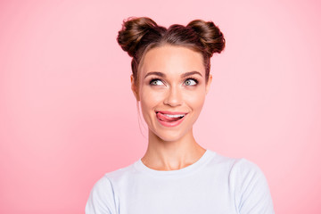 Close-up portrait of her she nice cute lovely attractive cheerful cheery funny girl with buns licking lips isolated over pink pastel background