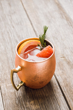 Grapefruit moscow mule in copper mug on the rustic background. Selective focus. Shallow depth of field. 