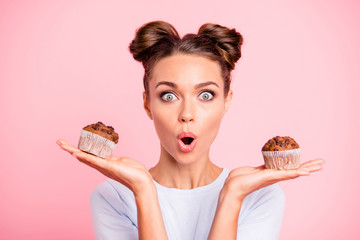 Close-up portrait of nice lovely cute attractive amazed scared afraid girl holding in hands two...
