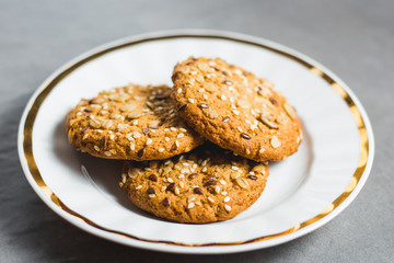 Tasty cookies in a white dish are ready for eating
