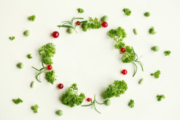  parsley and berries shaped as frame on yellow background