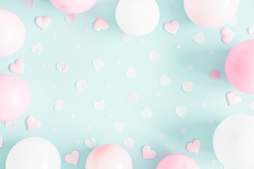 Balloons on pastel blue background. Frame made of white and pink balloons. Birthday, valentines day, holiday concept. Flat lay, top view, copy space
