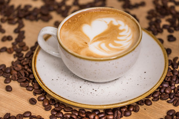 Close up coffee cup with heart latte art on table