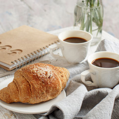 Breakfast with coffee and croissant