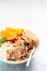 Farm cottage cheese with apple crumble or crisp served with tangerine, mint and honey. Healthy breakfast or dessert. Copy space. 