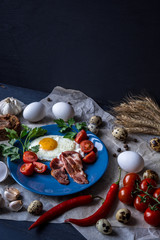 Fried eggs delicious breakfast on dark background, top view