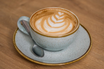 Close up coffee cup with heart latte art on table