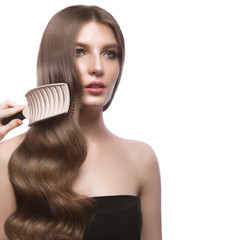 Beautiful brown-haired girl with a perfectly smooth hair, and classic make-up. Beauty face.