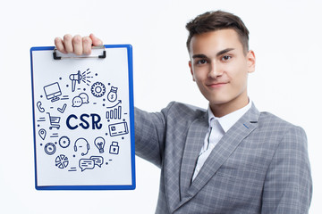 Business, technology, internet and networking concept. Young entrepreneur showing keyword: CSR