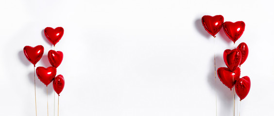 Set of Air Balloons. Bunch of red color heart shaped foil balloons isolated on white background. Love. Holiday celebration. Valentine's Day party decoration. Metallic red  Heart air balloons