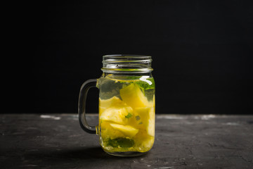Fresh pineapple detox drink in jar. Selective focus.