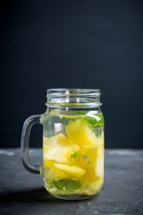 Fresh pineapple detox drink in jar. Selective focus.