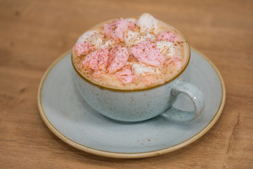 coffee with foamed cream and cinnamon powder