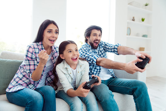 Portrait of nice cute lovely attractive cheerful cheery positive funny people mom dad spending spare time attending contest winning in light white modern interior indoors