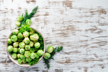 Brussels cabbage on a white wooden background. Vegetables. Top view. Free space for your text.