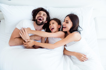 Top above high angle view of nice cute sweet lovely adorable attractive cheerful cheery glad people lying in bed enjoying cuddling daddy in modern white light interior room indoors