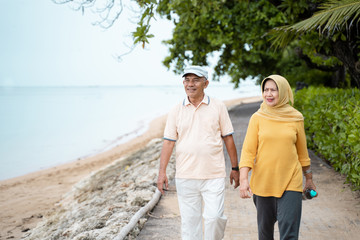 senior asian couple walking and exercising