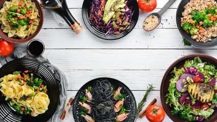 Food Background. Pasta, rice, risotto, salad. On a white wooden background. Free copy space.