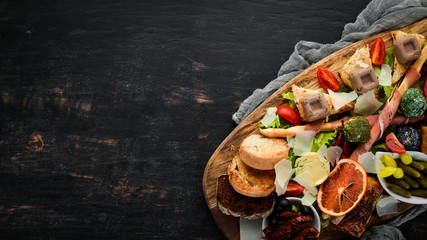 A set of food. Snacks of Italian cuisine. On a wooden background. Top view. Free copy space