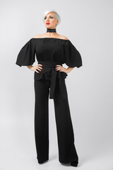 Fototapeta premium Vertical portrait of a woman in a suit in full height