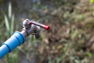 Top view of the water tap in the countryside, water saving concept