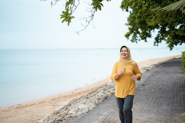 muslim mature woman doing exercise outdoor