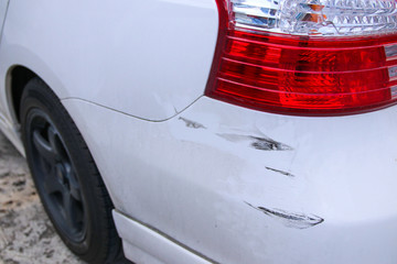 White car bumper scratch from accident.