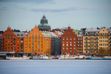  Boats in Stockholm at Kungsholmen a winter day in pale sun light