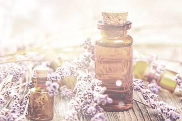 Pile of lavender flowers and a dropper bottle with lavender